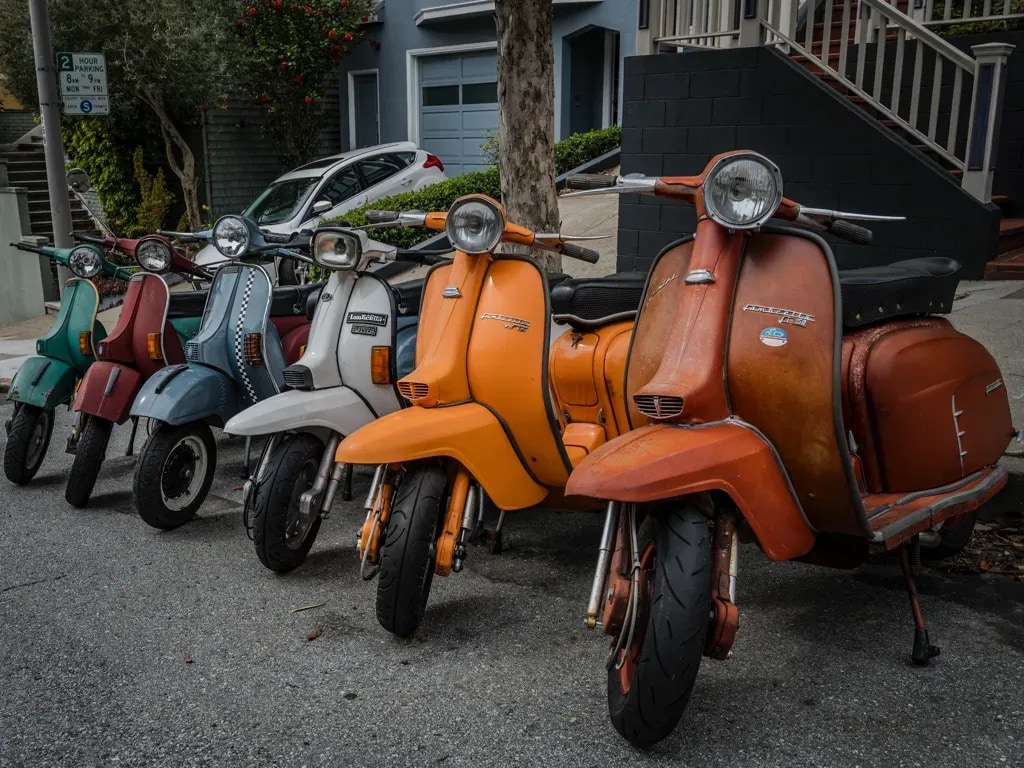 A row of classic weathered scooters on a San Francisco street