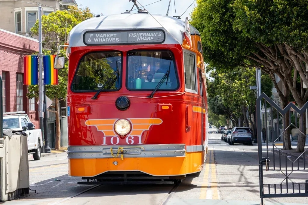 Historic red-and-orange F-line streetcar 1061 bound for Fisherman's Wharf, San Francisco
