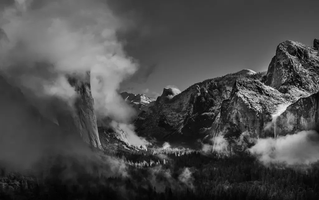 Tunnel View with cloud swallowing El Capitan, Half Dome and Bridalveil Fall beyond, Yosemite, black and white