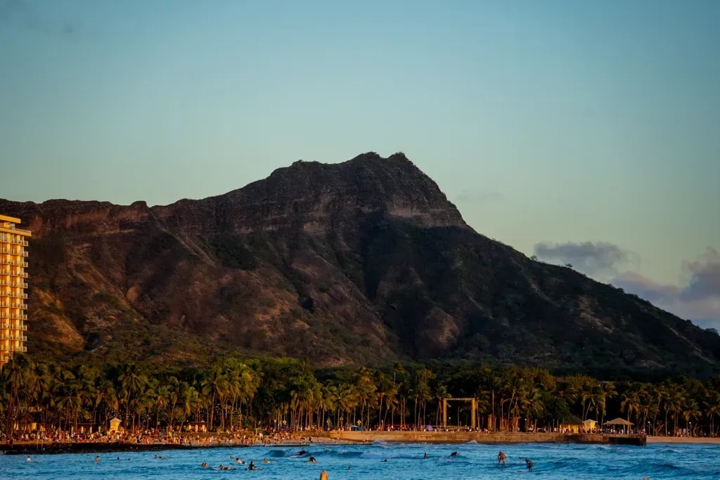 Diamond Head crater at golden hour above Waikiki's surf, Honolulu, Hawaii